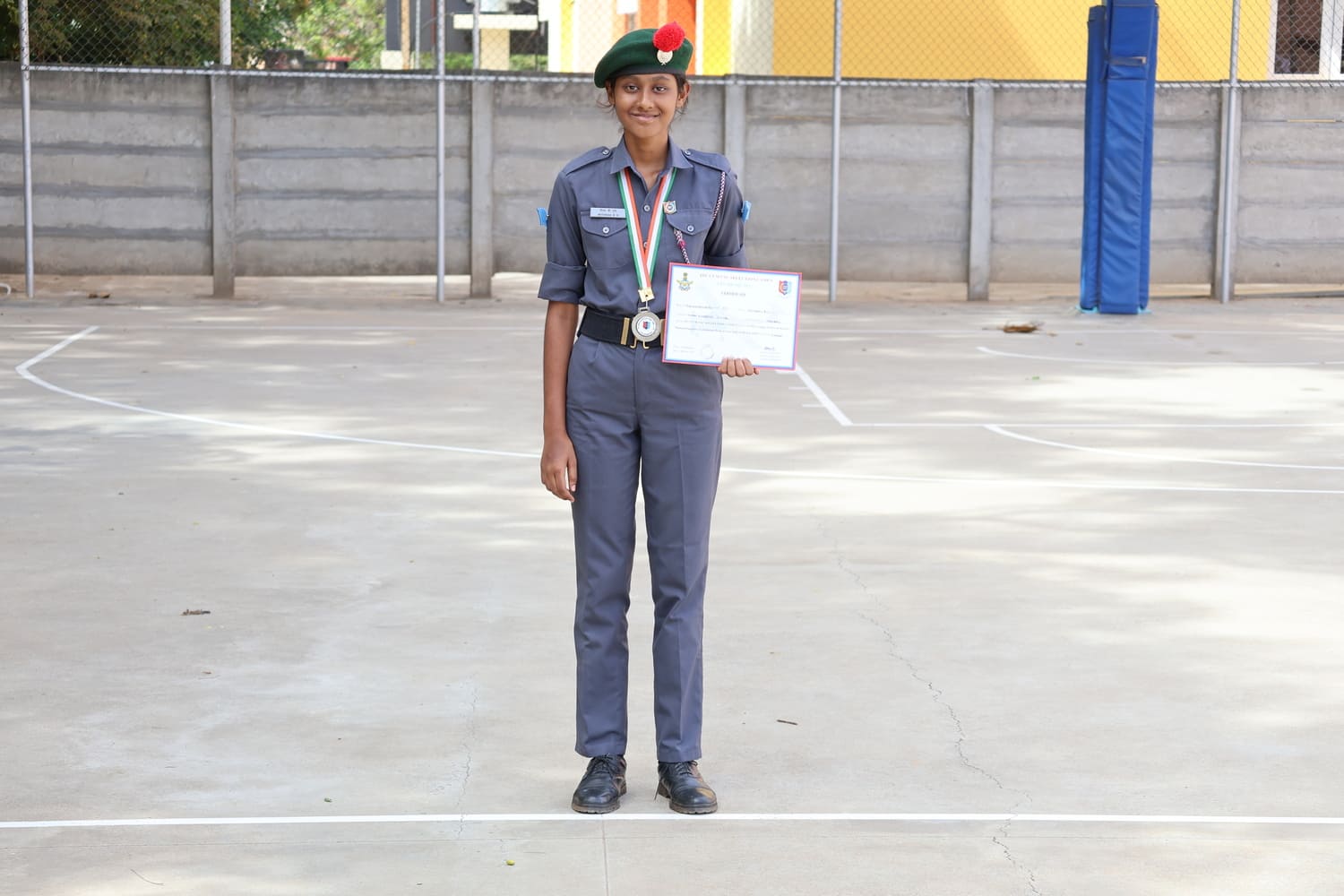 Throwball runner-up with her medal and certificate